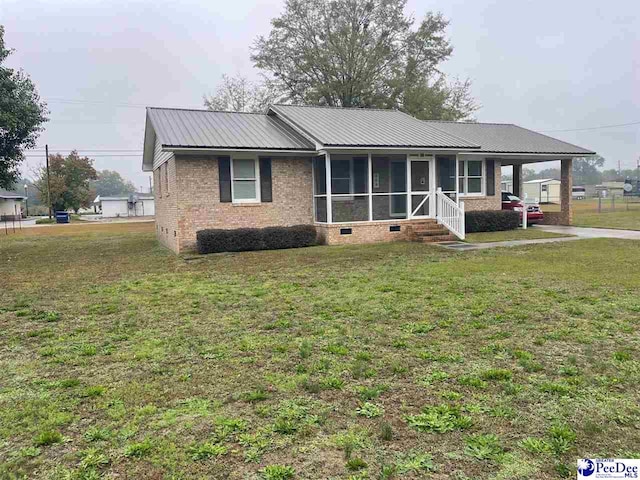 view of front facade featuring a front lawn and a sunroom