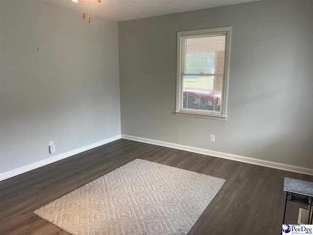 spare room featuring dark hardwood / wood-style floors