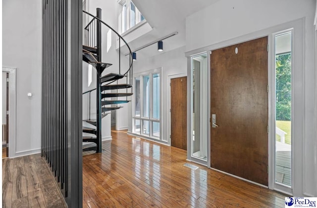 entryway with a high ceiling and hardwood / wood-style floors