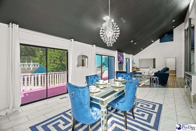 dining area featuring high vaulted ceiling, a healthy amount of sunlight, and a chandelier