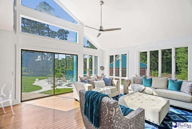 sunroom with ceiling fan and lofted ceiling