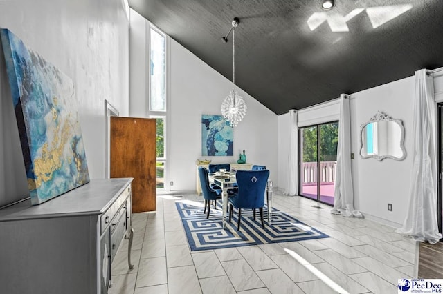 dining area featuring an inviting chandelier, light tile patterned floors, high vaulted ceiling, and a textured ceiling