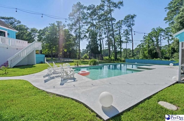 view of pool with a yard and a patio area