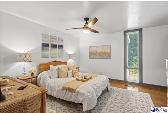 bedroom with ceiling fan and light hardwood / wood-style flooring