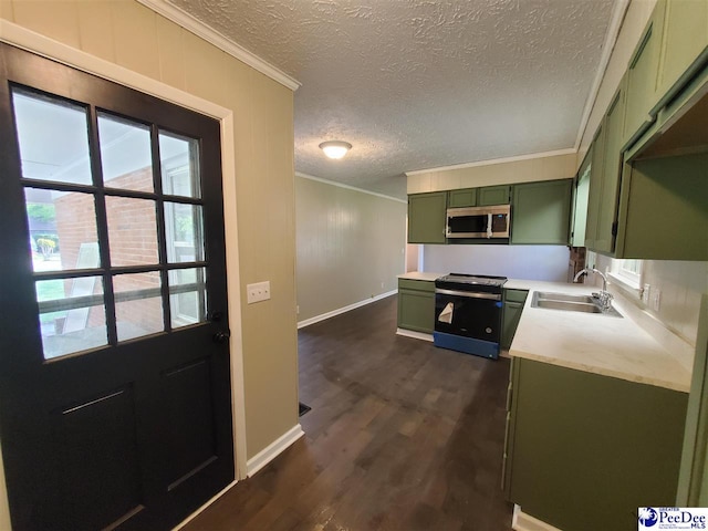 kitchen featuring electric range oven, green cabinetry, a sink, ornamental molding, and stainless steel microwave