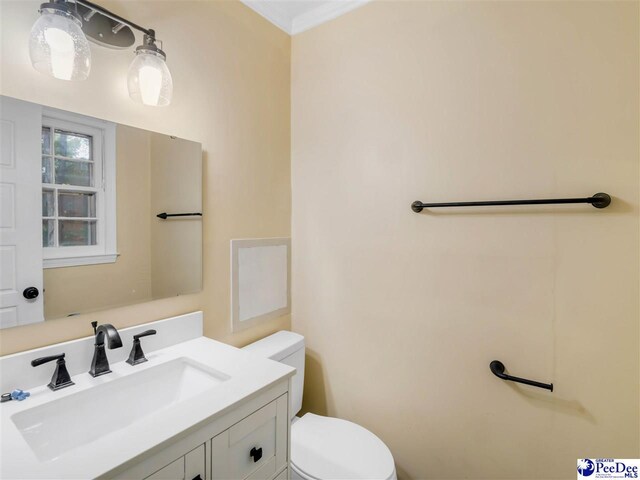1341 Marshall Ave, Florence, SC 29501 - bathroom featuring toilet, vanity, and crown molding