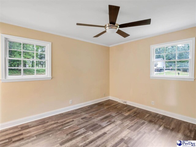 1341 Marshall Ave, Florence, SC 29501 - unfurnished room with dark wood-type flooring, plenty of natural light, baseboards, a ceiling fan, and ornamental molding