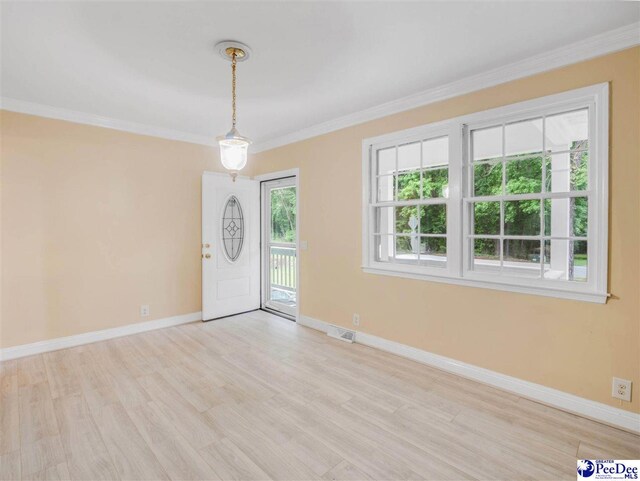 1341 Marshall Ave, Florence, SC 29501 - foyer entrance featuring crown molding, light wood-style floors, and baseboards