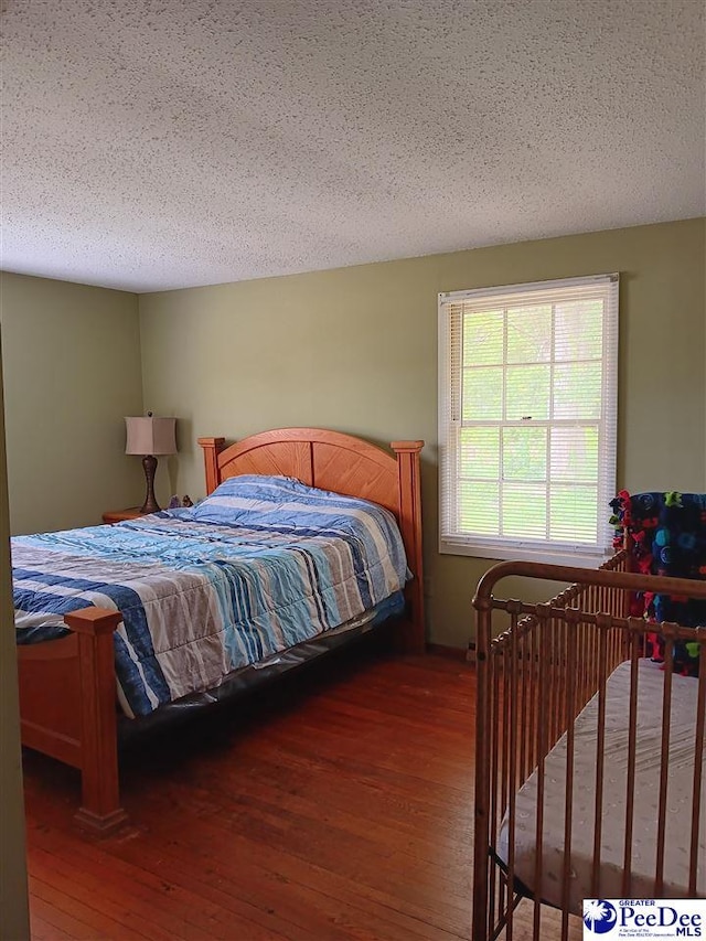 702 New Hampton Rd, Hartsville, SC 29550 - bedroom with hardwood / wood-style floors and a textured ceiling