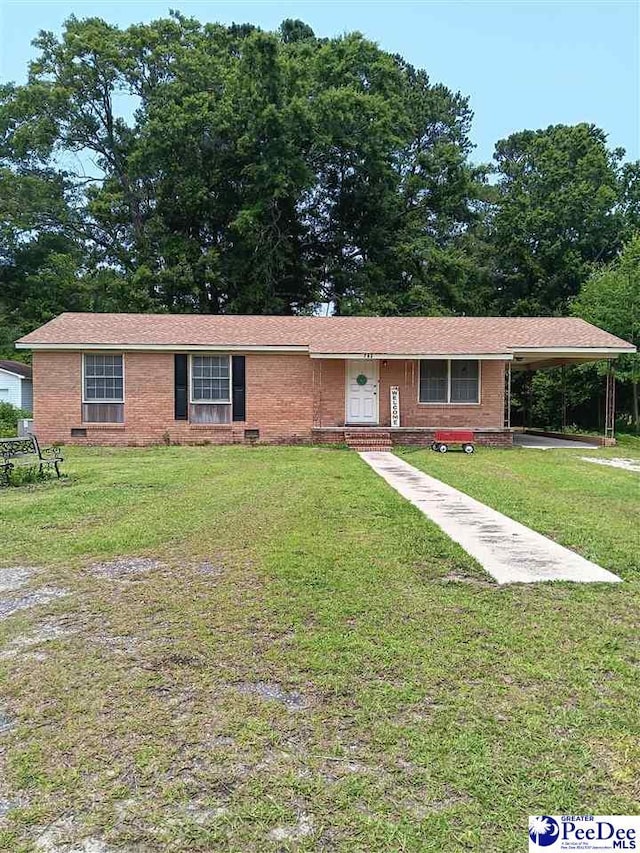 702 New Hampton Rd, Hartsville, SC 29550 - ranch-style house featuring brick siding, a front yard, and a carport