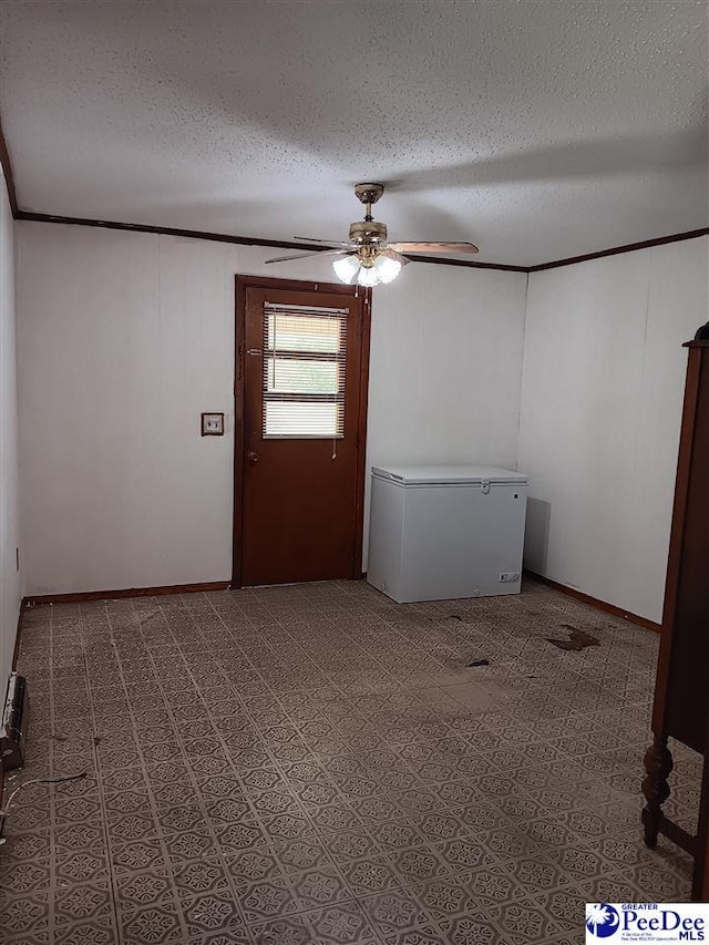 702 New Hampton Rd, Hartsville, SC 29550 - empty room featuring a textured ceiling, ceiling fan, crown molding, and baseboards