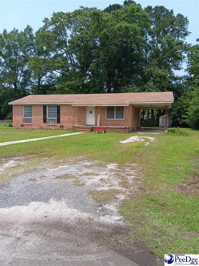 702 New Hampton Rd, Hartsville, SC 29550 - single story home with a front lawn, an attached carport, brick siding, and driveway