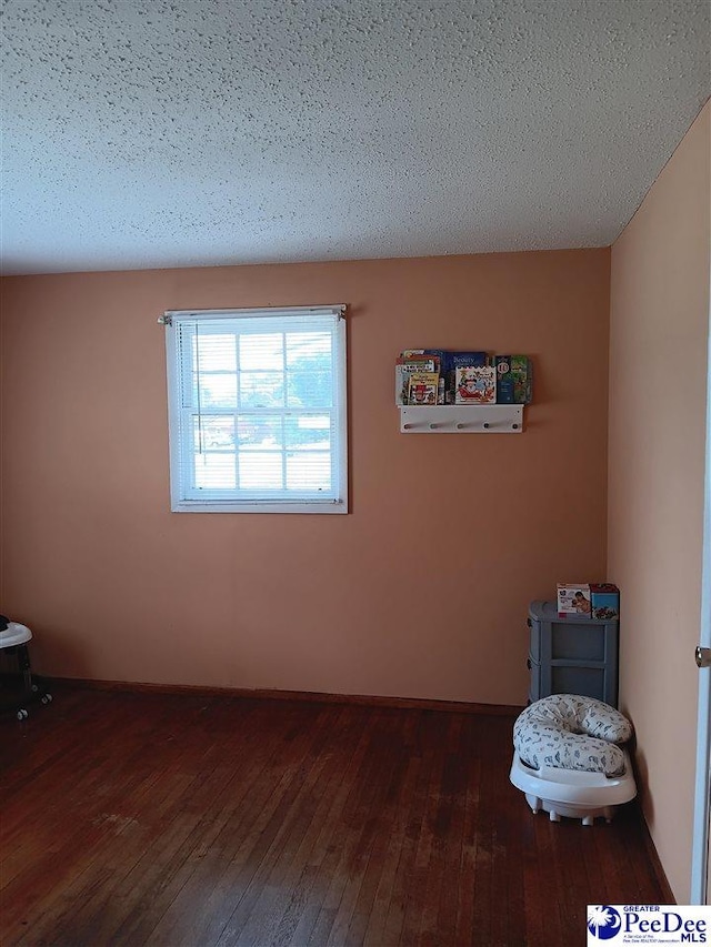 702 New Hampton Rd, Hartsville, SC 29550 - empty room with dark wood-type flooring and a textured ceiling