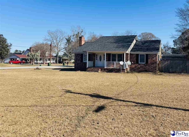 ranch-style house featuring a front yard and covered porch