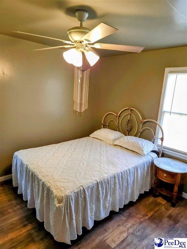 bedroom featuring dark hardwood / wood-style flooring and ceiling fan