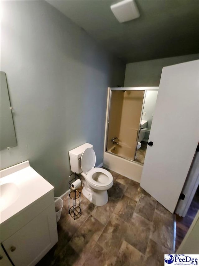 full bathroom featuring vanity, toilet, and combined bath / shower with glass door