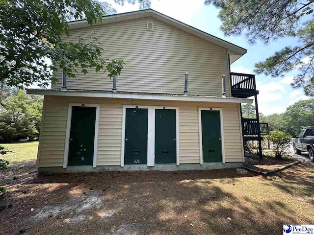 rear view of property with a balcony