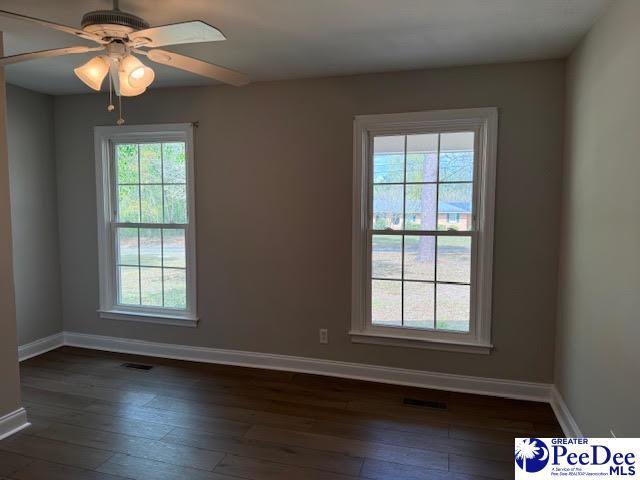 270 Quinby Cir, Quinby, SC 29506 - empty room featuring dark wood-style flooring, baseboards, a ceiling fan, and visible vents