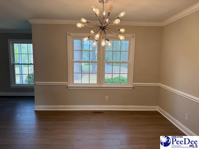 270 Quinby Cir, Quinby, SC 29506 - unfurnished dining area featuring visible vents, an inviting chandelier, ornamental molding, and dark wood finished floors