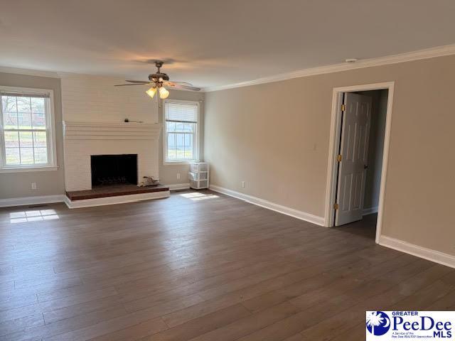 270 Quinby Cir, Quinby, SC 29506 - unfurnished living room with dark wood-style floors, ceiling fan, baseboards, and ornamental molding