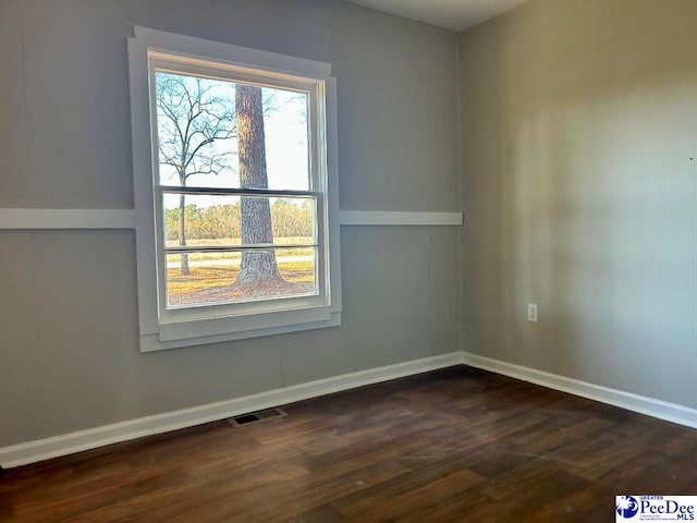 spare room with dark hardwood / wood-style flooring