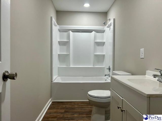 full bathroom featuring wood-type flooring, toilet, shower / bath combination, and vanity