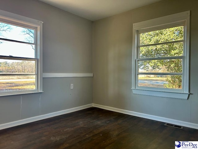 empty room with dark hardwood / wood-style floors