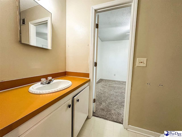 bathroom with vanity and a textured ceiling