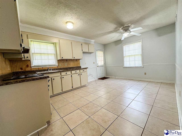 kitchen with sink, light tile patterned floors, ceiling fan, black gas cooktop, and cream cabinetry