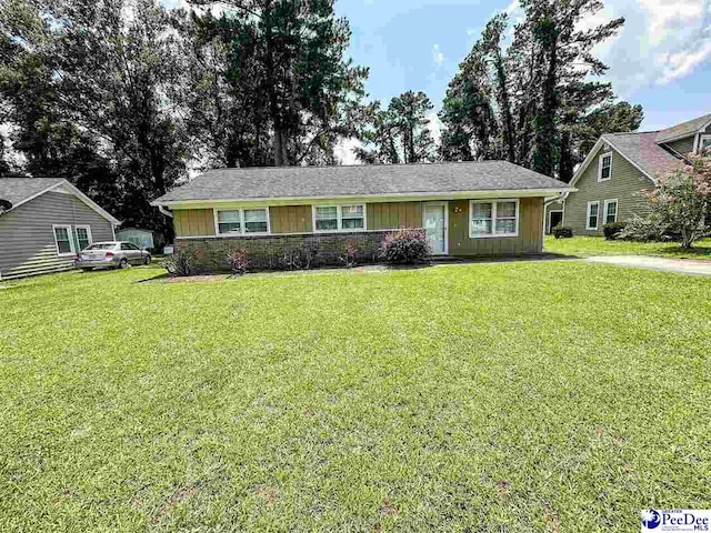 single story home featuring a front lawn