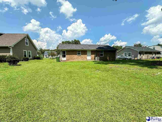 back of house featuring a yard