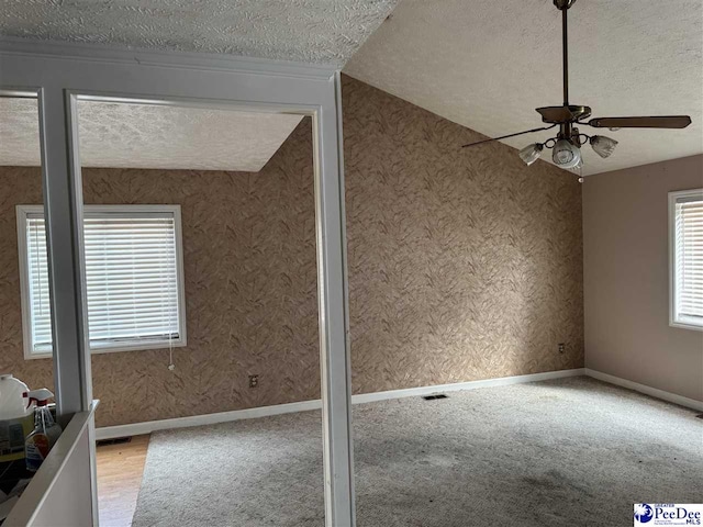 interior space with baseboards, visible vents, and a textured ceiling