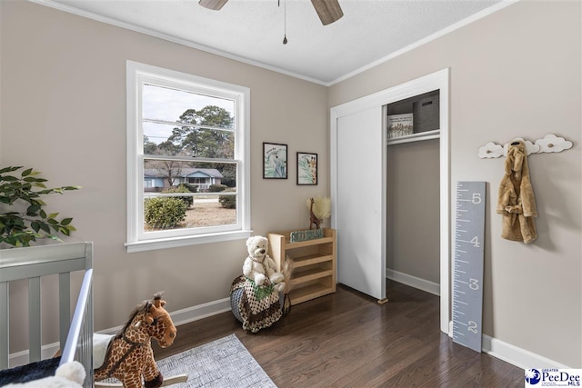 bedroom with ceiling fan, ornamental molding, dark hardwood / wood-style floors, and a closet