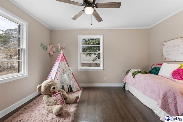 bedroom with crown molding, dark wood-type flooring, and ceiling fan