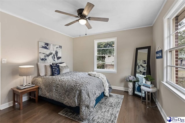 bedroom with crown molding, dark hardwood / wood-style floors, and ceiling fan