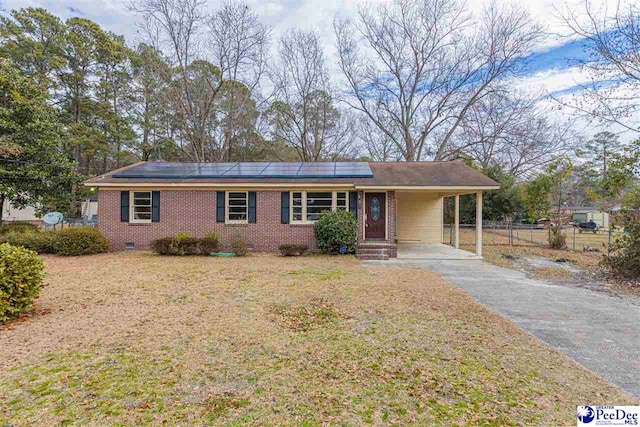 ranch-style home with a carport and a front lawn