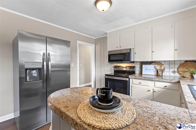 kitchen with white cabinetry, backsplash, stainless steel appliances, ornamental molding, and a textured ceiling