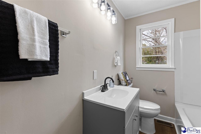 bathroom with vanity, crown molding, and toilet