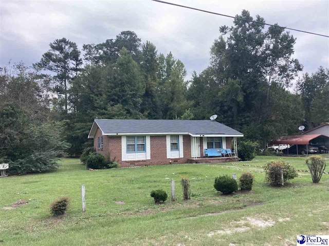 ranch-style house with covered porch and a front lawn