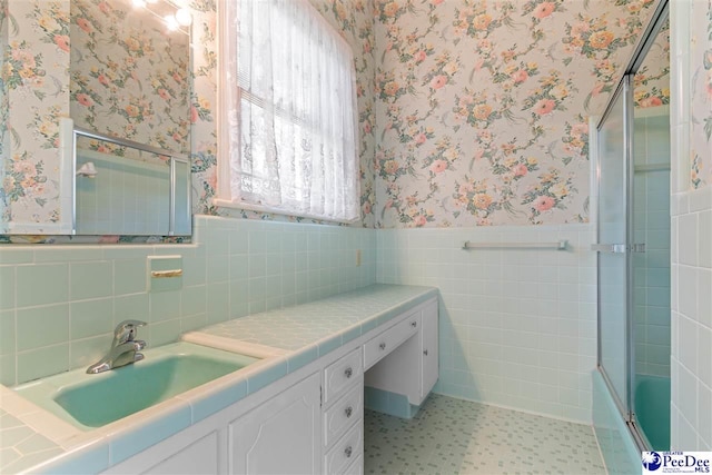 118 Ford Ave, Mullins, SC 29574 - bathroom featuring wallpapered walls, a wainscoted wall, vanity, tile patterned floors, and bath / shower combo with glass door