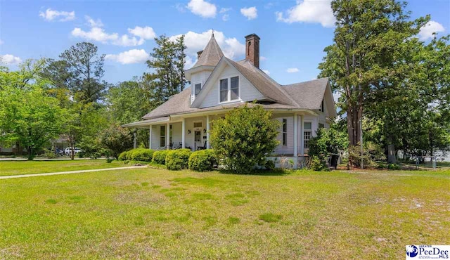 118 Ford Ave, Mullins, SC 29574 - view of front of property featuring a chimney, a front lawn, and covered porch