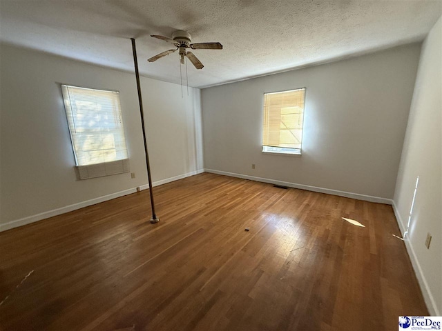 unfurnished room featuring ceiling fan, wood-type flooring, and a textured ceiling