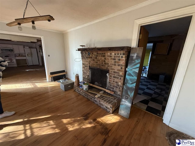 living room featuring hardwood / wood-style flooring, crown molding, a textured ceiling, and a fireplace