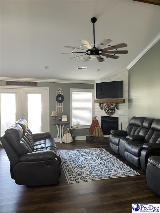 living room with hardwood / wood-style floors, a fireplace, and ornamental molding