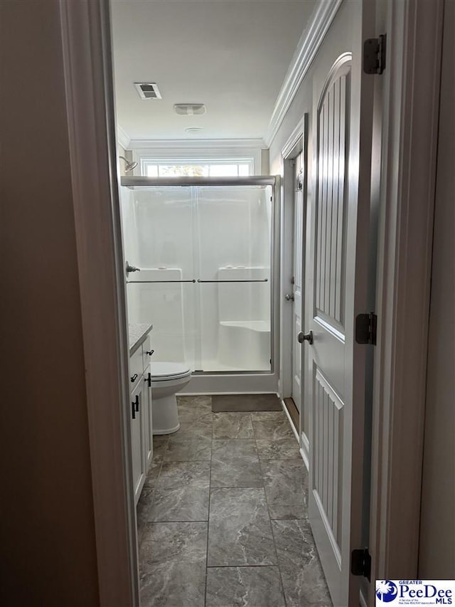 bathroom featuring crown molding, vanity, toilet, and walk in shower