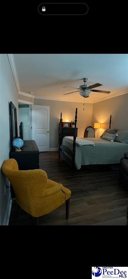 bedroom featuring hardwood / wood-style floors, crown molding, and ceiling fan