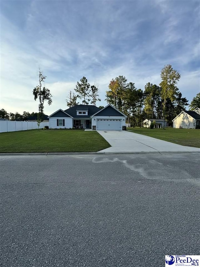 view of front of home featuring a garage and a front lawn