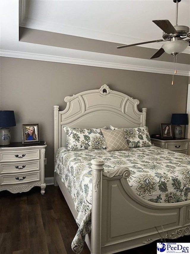 bedroom featuring dark wood-type flooring, ceiling fan, and ornamental molding