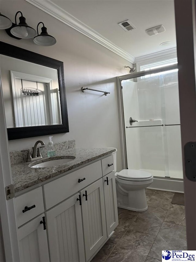 bathroom with ornamental molding, toilet, a shower with door, and vanity