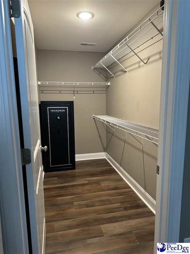 walk in closet featuring dark wood-type flooring